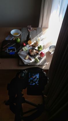 a table topped with food next to a window