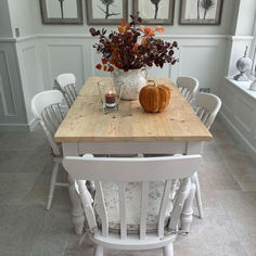 A photograph of a dining table with a velvet pumpkin and autumnal foliage for decoration White Chairs Pine Table, White Wood Dining Table Rustic, Shabby Chic Oak Table, Stained Table With White Base, White Farmhouse Kitchen Tables, White Wax On Oak Table, White Dining Room Uk, Farmhouse White Tables, Whitewash A Table