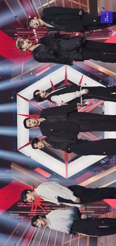 four people standing in front of a red and white background