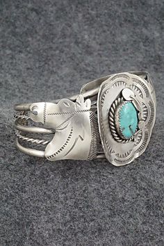 This amazing turquoise and sterling silver bracelet featuring horses and a hat a with feather in the brim was made by Navajo silversmith Tim Yazzie. The back is signed T Yazzie and stamped sterling.Size: 5 5/8" (will fit up to a 6 7/8" wrist)Gap: 1 1/4"Width: 1 5/8"Free shipping on all orders! We ship with USPS and always include tracking. All orders ship within a day of payment.Returns are accepted up to 30 days after you receive your order. Just send us a message. Our shop offers cash back or Sterling Silver Bracelet, Turquoise Sterling Silver, Sterling Silver Bracelets, Silver Bracelet, Gap, Horses, Turquoise, Bracelet, Sterling Silver