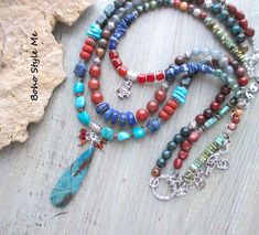 Colorado Springs, Boho Style Me Colorful Rustic Style Multi Strand Gemstone Necklace, BohoStyleMe, Artisan Beaded Turquoise Necklace In the style of the rustic Colorado mountains, this colorful, rustic, mixed gemstone necklace stands out as a striking multiple strand statement necklace. Starting with a beautiful chrysocolla beaded pendant is a trail of genuine turquoise, lapis lazuli, carnelian, labradorite, iolite, sodalite, and a large mix of jasper stones. Directly above the pendant is strand Blue Bohemian Beaded Necklaces With Stones, Bohemian Blue Beaded Necklaces With Stones, Handmade Multicolor Bohemian Turquoise Necklace, Multicolor Bohemian Turquoise Necklace With Round Beads, Multicolor Bohemian Turquoise Necklace With Stones, Bohemian Multicolor Turquoise Necklace With Round Beads, Bohemian Multicolor Turquoise Necklace With Stones, Bohemian Multicolor Turquoise Beads Necklace, Multicolor Turquoise Bohemian Necklace