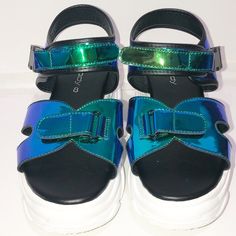 Unilady “Tanya-1” Mix Media Neon Blue Hologram Sandal. Platform Heel With A Sneaker Feel. Buckle Clasp And Velcro. When The Light Hit These The Colors Really Pop. Blues, Greens And Purples. Super Cool And Chic Shoe To Own. New/ Size 8 Trendy Blue Sandals With Ankle Strap, Trendy Blue Sandals For Party, Trendy Blue Party Sandals, Brown Leather Flip Flops, Blush Shoes, Memory Foam Sandals, Tan Leather Sandals, Yellow Sandals, Ankle Tie Sandals