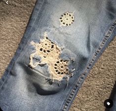 an old pair of jeans with holes in them