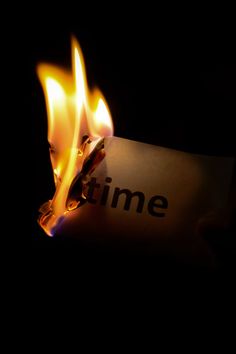 a lit matchstick with the word time on it and flames coming out of it