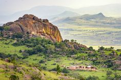 an area with mountains, rocks and houses