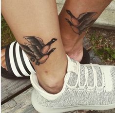 two people with matching tattoos on their feet, one has a bird and the other has a