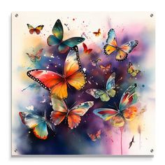 colorful butterflies flying in the sky with watercolor paint on it's back side