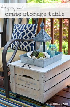 a wooden crate sitting on top of a patio table filled with plants and other items