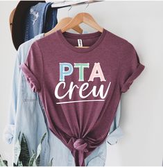 a shirt that says pata crew on the front, and a pair of jeans behind it