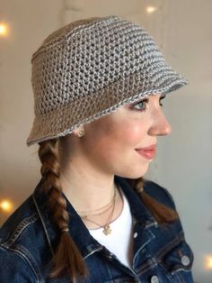 a woman wearing a hat with braid hair