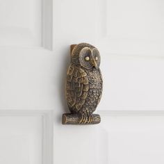 an owl figurine is sitting on the door handle