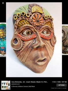 a wooden mask with an intricate design on it's face and two different colored eyes