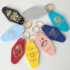 six different colored plastic key chains on a white surface