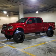 a red truck parked in a parking garage