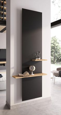 two shelves with books on them in a living room next to a wall mounted clock