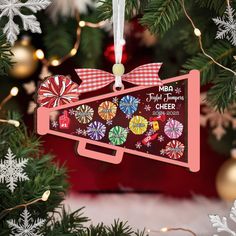 an ornament hanging from a christmas tree decorated with candy canes and snowflakes