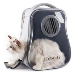 a white cat laying on top of a blue and silver suitcase with speakers attached to it