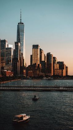 there is a boat that is in the water and some buildings are in the background