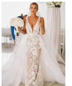 a woman in a wedding dress is walking down the aisle with her bridal gown