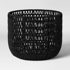 a black basket that is sitting on the ground