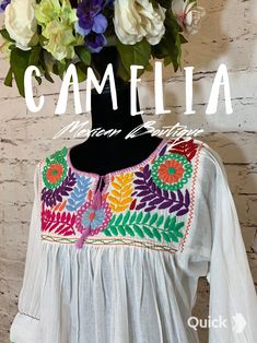 Mexican tunic with frontal neck embroidery on a soft and fresh gauze fabric. 3/4 inch sleeve has embroidery and tassel detail. Match it up with our comfortable embroidered espadrilles and embroidered tasseled clutch. SIZE CHART: td {border: 1px solid #ccc;}br {mso-data-placement:same-cell;} MEXICAN EMBROIDERED TUNIC FLOWERS WIDTH BUST LENGTH ONE SIZE 20" 40" 29" approximate measurements are in inches COLOR: Color options are based on embroidery design. CARE:• Cold wash, delicate, inside out. • H Embroidered Knots, Rococo Embroidery, Embroidered Espadrilles, Mexican Top, Gauze Tunic, Mexican Blouse, Neck Embroidery, Blouse Sale, Embroidered Tunic