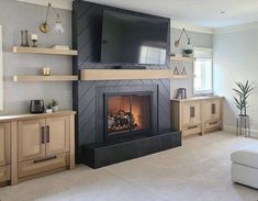 a living room filled with furniture and a flat screen tv mounted on the wall above a fire place