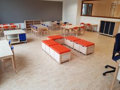 an empty classroom with multiple tables and chairs