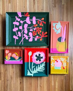 four framed paintings on the wall with flowers and plants painted on them in different colors