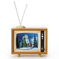 an old fashioned television with a christmas scene on it