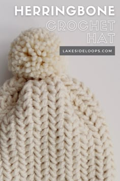 a white knitted hat with the text, herringbone crochet hat on it