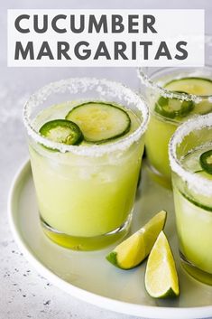 cucumber margaritas on a plate with lime slices