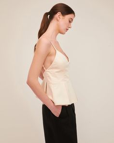 The Emily top offers a flattering fitted waist with an easy open back. The peplum hem is updated with structured pleating details. Dress the Emily down with denim or pair her with the Solea Linen Wide Leg Trouser for an elegant and refined look for a night out. Fitted at bust and empire Bodice lined in self fabric Back zipper closure Adjustable shoulder straps with adjustable back strap Pleated peplum 64% Cotton, 31% Nylon, 5% Spandex Model is 5’10” and wearing a size S.This style runs large. We Peplum Tops, Marissa Webb, Peplum Hem, Back Strap, Shoulder Straps, Open Back, Peplum Top, Bodice, Night Out