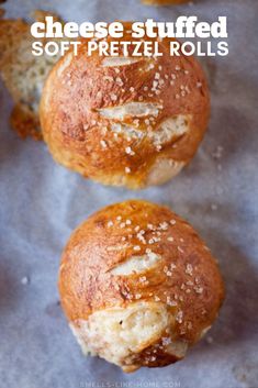 three bread rolls with sesame seeds on top