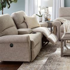 a living room with two recliners and a coffee table in front of the couch