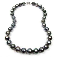 "Absolutely gorgeous and rare single 18\" strand (length including the clasp) 100% authentic Tahitain black pearl necklace strand with 14K solid white gold clasp Pearl: a total of 33 100% authentic fine quality A & B grade (Please refer to the below A-D pearl grading system for details) Tahitian black pearls Pearl measurement: 11.5-14.2mm in diameter (11.5mm pearls at the ends and 14.2mm in the center) Color: all natural black with beautiful green overtone (not dyed or treated) Shape: round Classic Tahitian Pearl Necklace With Round Beads, Classic Tahitian Pearl Round Bead Necklaces, Classic Tahitian Pearl Round Bead Necklace, Classic Tahitian Pearl Beaded Necklace, Formal Black Tahitian Pearl Necklaces, Classic Tahitian Pearl Necklace With High Luster, Classic Round Tahitian Pearl Necklace, Classic Round Tahitian Pearl Necklaces, Classic Tahitian Pearl Round Necklaces