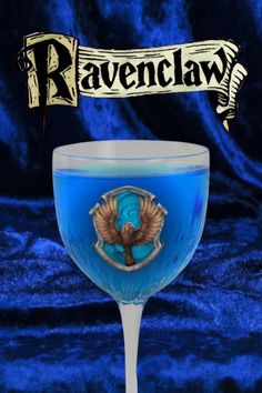 a blue wine glass with the name raven claw on it and an eagle emblem above it