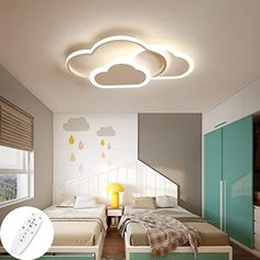 a bedroom with two beds and a sky shaped light above the headboard on the ceiling