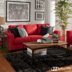 a living room with red couches and black rugs