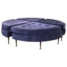 a blue round couch sitting on top of a wooden table