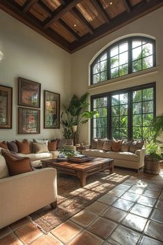 a living room filled with furniture and large windows