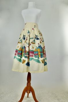 This 1950s cotton skirt will delight you with its abstract scenes of the BOARDWALK. On beige cotton background, hot pink, teal, blue, and gold are the dominant colors creating a scene with sea gulls, waves, boats, stores, and people. DARLING! two buttons and metal zipper in back LABEL: none CONDITION: excellent plus / clean and bright MEASUREMENTS: waist: 26 in. hips: full length: 30 in. sweep of skirt: 35 in. Vintage Fitted Cotton Skirt, Vintage Cotton Flared Skirt, Retro Cotton Gathered Skirt, Vintage Cotton Flared Skirt Bottoms, Retro Skirted Cotton Bottoms, Multicolor Cotton Full Skirt, Vintage Cotton Lined Skirt, Retro Cotton Lined Skirt, Vintage Multicolor Skirt