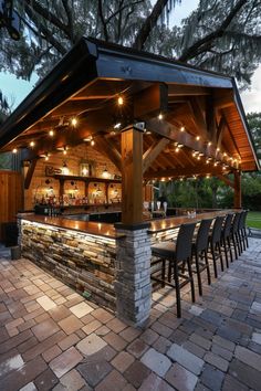 an outdoor bar is lit up with lights