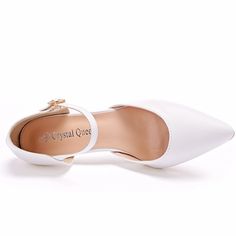 a pair of white shoes that are on top of each other, with the words crystal quest written in gold