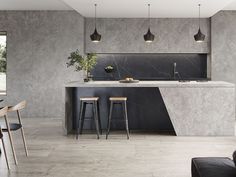 a kitchen with marble counter tops and stools