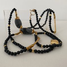 Wear this asymmetrical necklace long or double wrap it for a short necklace. Onyx gemstones are mixed with gold bars and gold beads. This necklaces is approximately 40 inches long. Asymmetrical Necklace, Gold Bars, Necklace Long, Gold Bar, Deep Black, Short Necklace, Gold Beads, Semi Precious Gemstones, Long Necklace