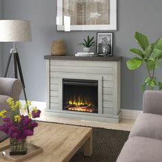 a living room with a couch, coffee table and fire place in front of the fireplace