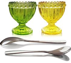 three different colored glass bowls with spoons