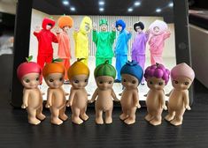 a group of small toy figurines sitting next to each other on a table