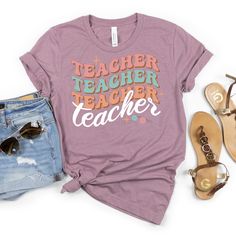 Teach your style a lesson with this Repeat Teacher Pattern Tee! This playful tee features a unique, repeating teacher pattern that's sure to make a statement. Show off your love for teaching in a fun and quirky way with this one-of-a-kind t-shirt. Trendy Fall T-shirt For School, Casual Relaxed Fit T-shirt For Back To School, Fun Short Sleeve Tops For Teaching, Fun T-shirt With Funny Print For Back To School, Casual Tops With Text Print For Teaching, Casual Tops With Funny Print For Teacher Appreciation, Cotton T-shirt For Teaching, Back To School, Back To School Graphic Tee For Teaching, Casual Tops For Teaching, Back To School