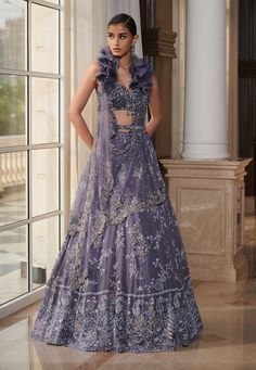 Editor's Note The set features a leaden blue chikankari lehenga with intricate embroidery and a shimmer tulle drape dupatta. It also includes a shimmer tulle embroidered blouse and an embroidered belt to complete the look. Fabric: Chikankari chiffon Color: Blue Components: Lehenga, blouse, belt and dupatta Occasion: Reception and wedding Disclaimer: Product color may slightly vary due to photographic lighting sources or your monitor setting. Care: Dry clean only About the Designer Dolly J is an Traditional Drape Lehenga With Chikankari Embroidery For Reception, Blue Choli With Chikankari Embroidery For Wedding, Chikankari Embroidered Lehenga For Eid Reception, Chikankari Embroidery Lehenga For Eid Reception, Eid Reception Lehenga With Chikankari Embroidery, Embroidered Organza Pre-draped Floor-length Saree, Embroidered Floor-length Organza Pre-draped Saree, Festive Chikankari Embroidered Lehenga For Reception, Festive Chikankari Lehenga For Reception